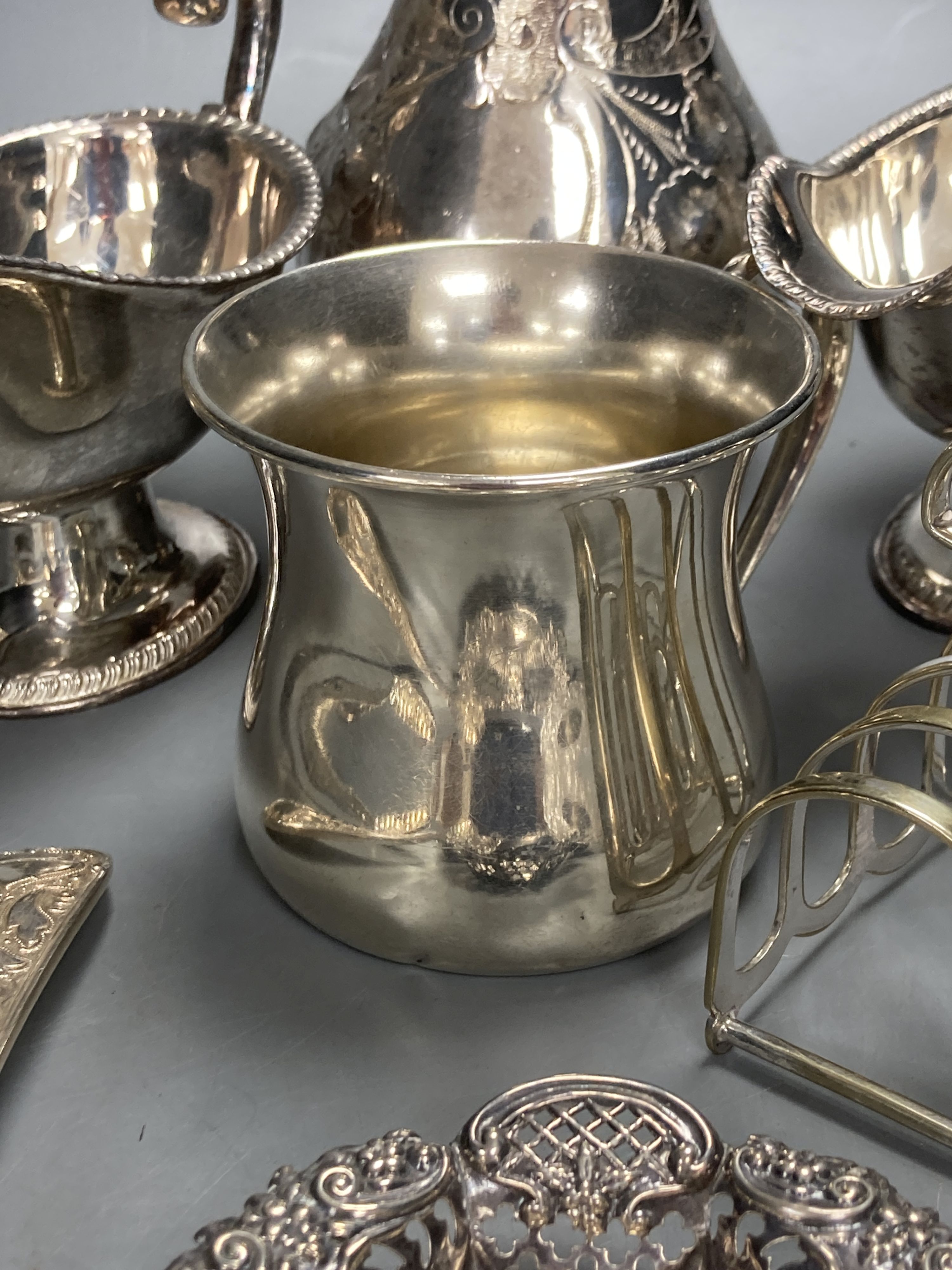 A sterling mug, a silver bonbon dish, a white metal strainer and a group of minor plated items.